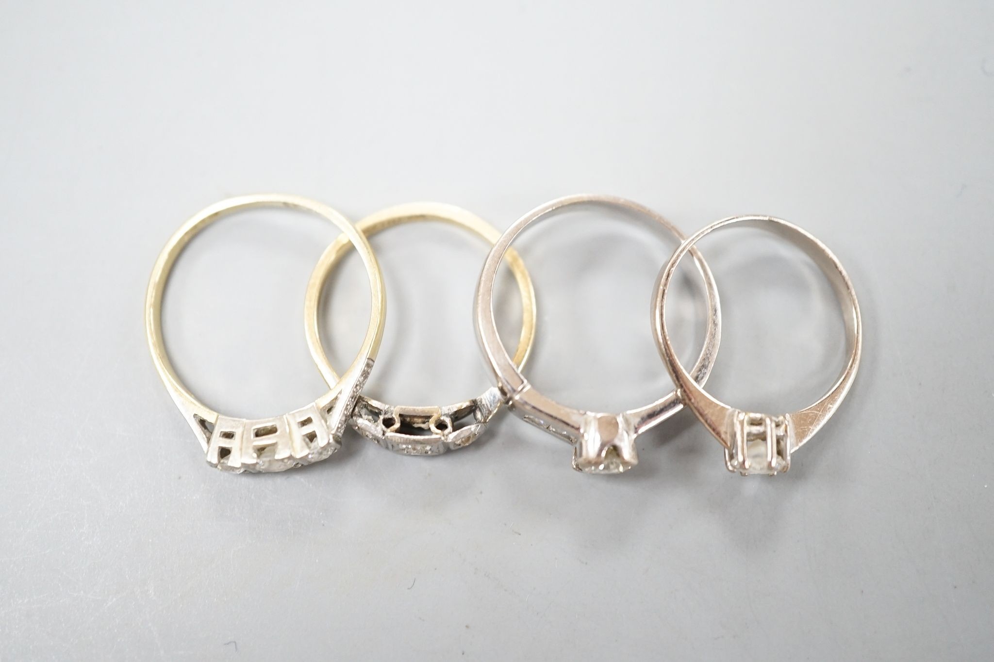 Four assorted diamond dress rings including two 18ct and two white metal, gross 10 grams